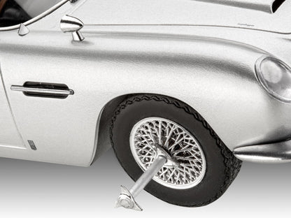 Adult hobbyist assembling Revell 14554 Aston Martin — manual dexterity and classic cinema nostalgia activity — Freetimejoy