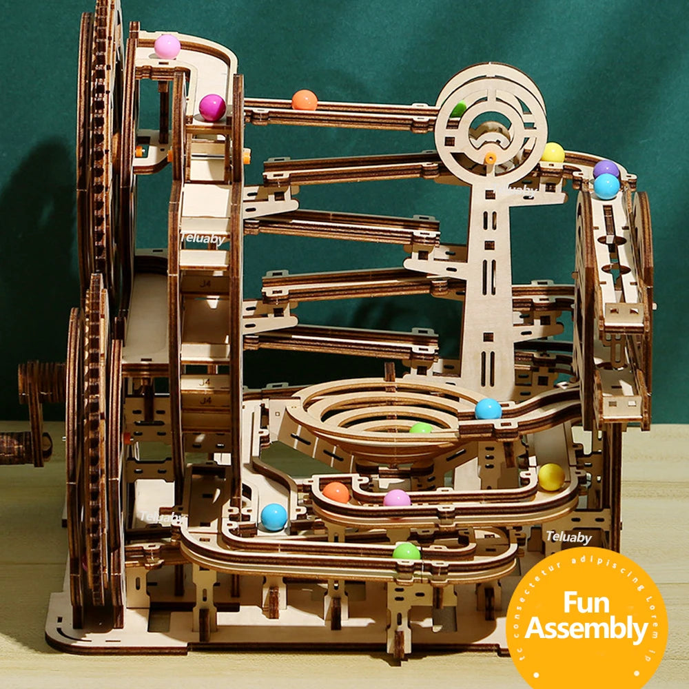 Two versions of Chriyungel mechanical marble runs: a large complex tower and a compact desktop version, both made of laser-cut wood with steel marbles.