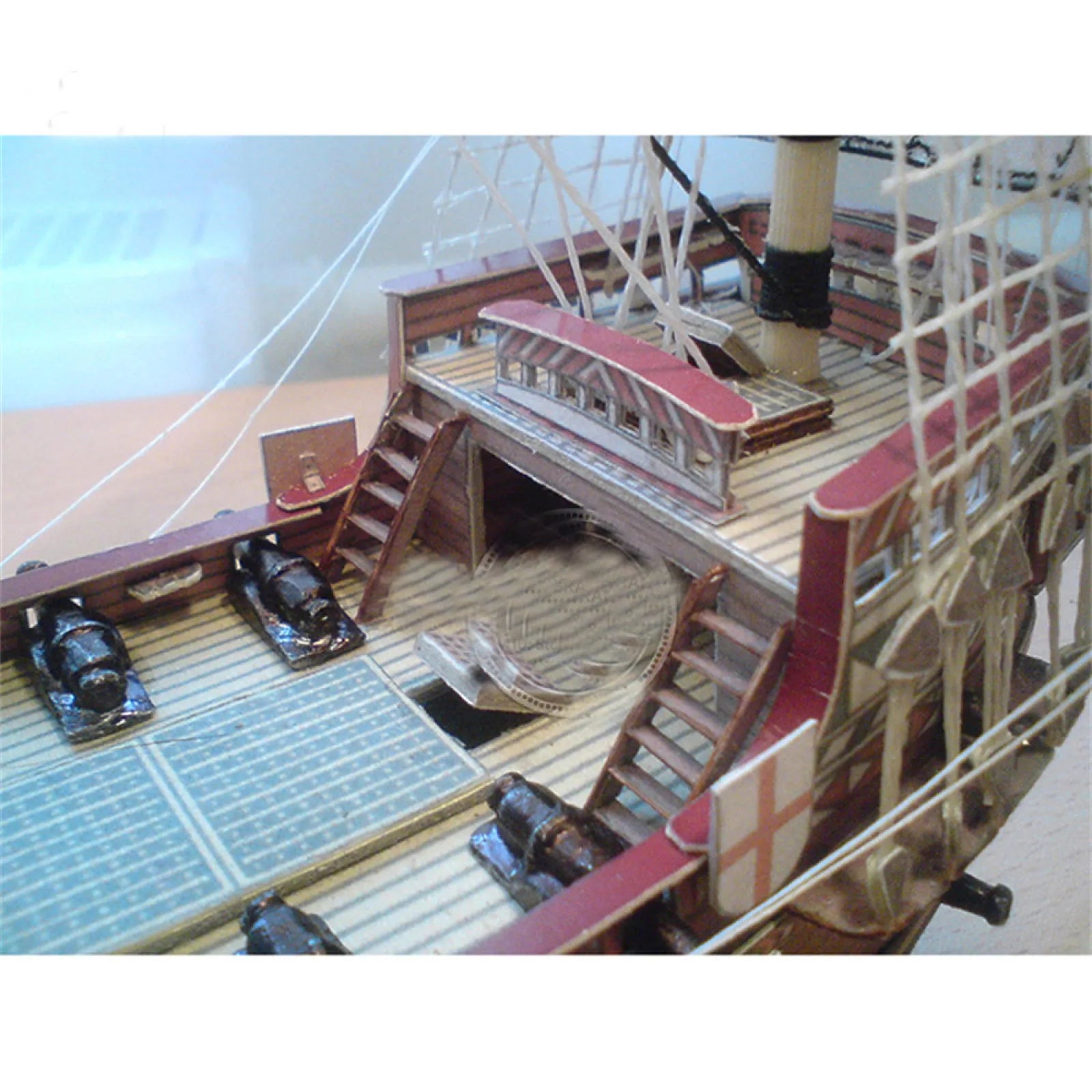 A professional completed paper model of the Golden Hind galeon at 1:100 scale, showcasing realistic paper textures and historical naval rigging.