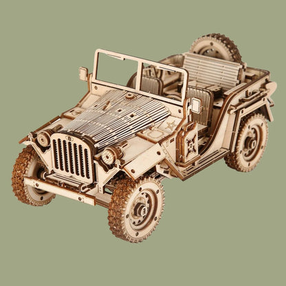 A completed vintage race car 3D wooden puzzle with detailed spoked wheels and open-cockpit design, displayed on a professional office desk.