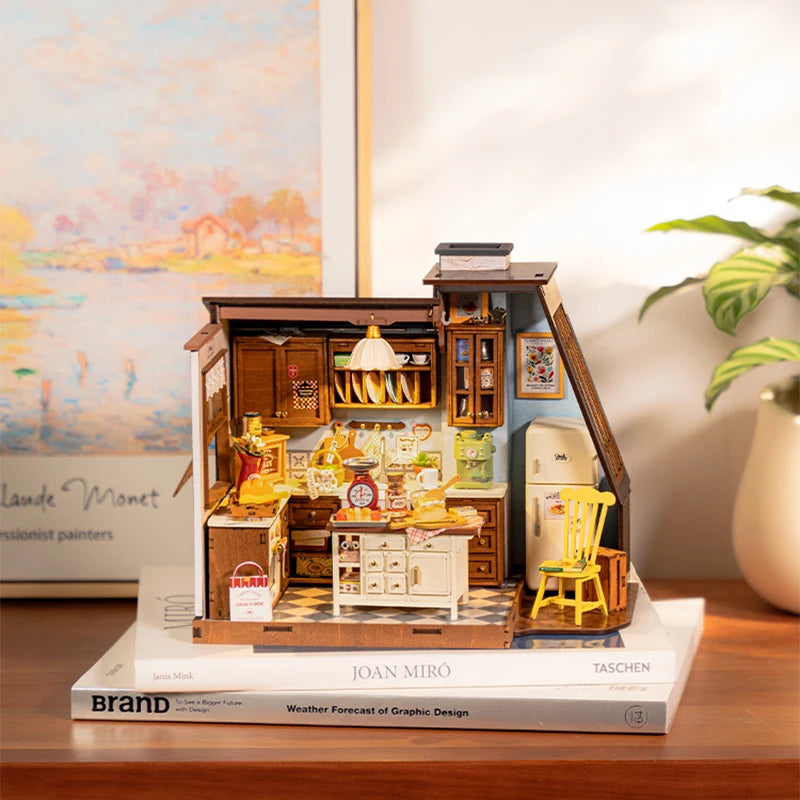 A fully assembled Rolife Baking Kitchen miniature house showing a vintage yellow chair, open oven with bread, and a glowing floral pendant lamp.