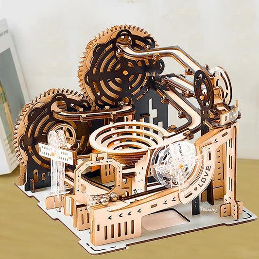 A completed mechanical marble run 3D wooden puzzle with intricate gears and steel marbles, showcasing kinetic engineering in a professional home office setting.