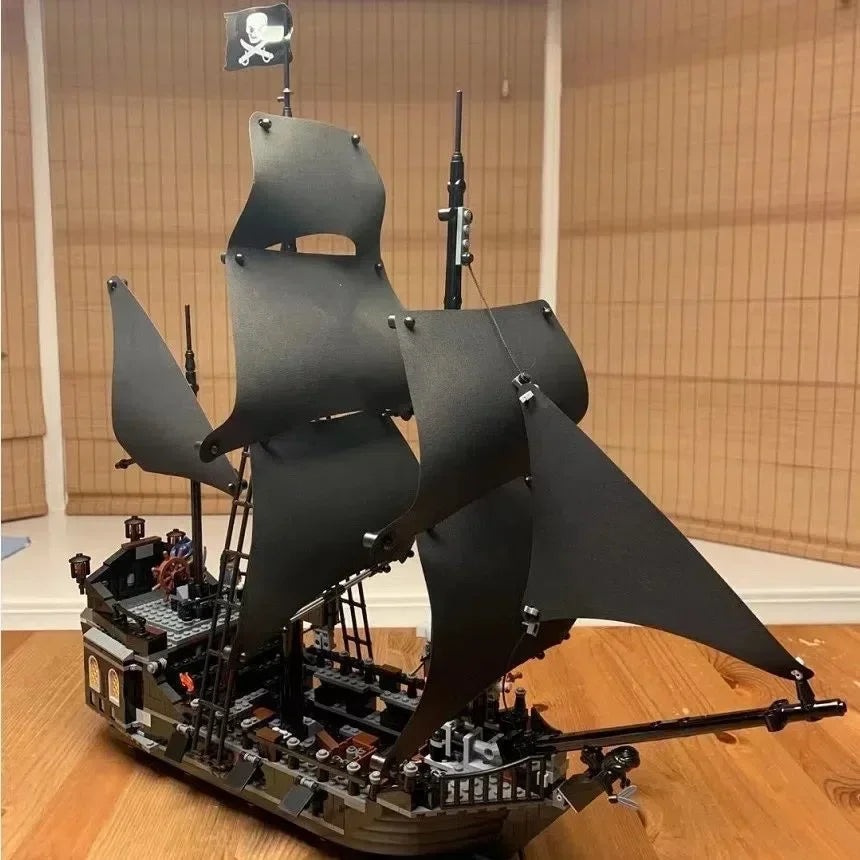 Detailed Black Pearl pirate ship building block model with black sails and over 800 pieces, displayed as a premium collector masterpiece.