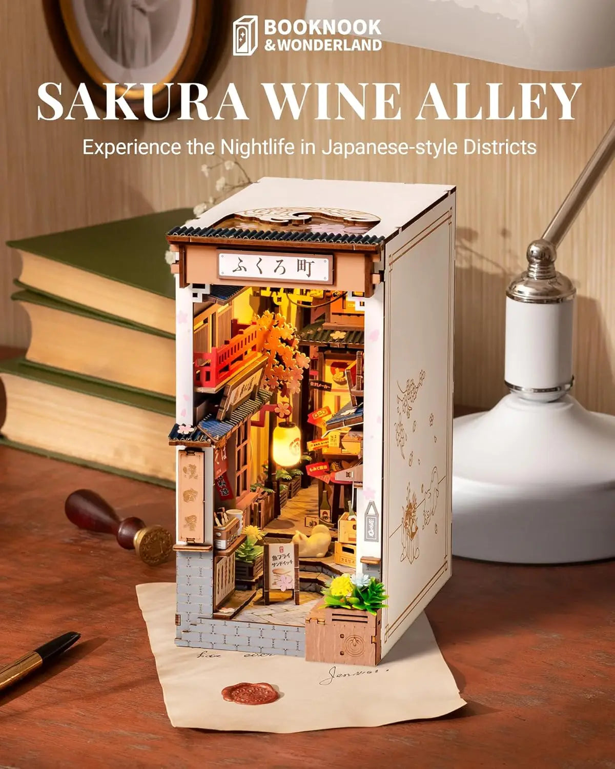 A completed Robotime Sakura Wine Alley Book Nook glowing with warm LED lights between books on a shelf, showing a detailed Japanese miniature street.