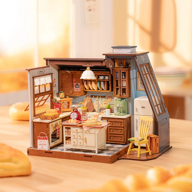 A fully assembled Rolife Baking Kitchen miniature house showing a vintage yellow chair, open oven with bread, and a glowing floral pendant lamp.