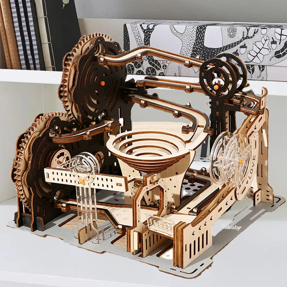A completed mechanical marble run 3D wooden puzzle with intricate gears and steel marbles, showcasing kinetic engineering in a professional home office setting.
